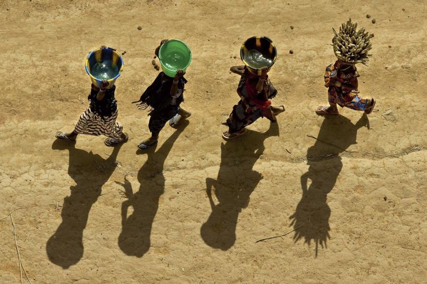 Young girls carrying buckets, Mali
